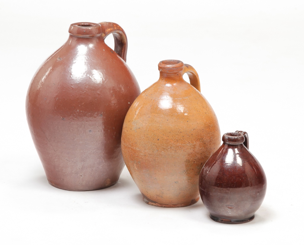 Appraisal: THREE AMERICAN REDWARE JUGS Mid th century Ovoid with applied