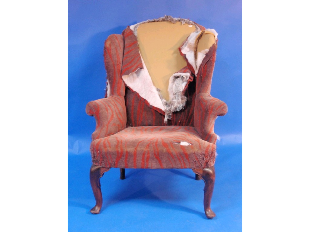 Appraisal: A Georgian wing back upholstered armchair with walnut cabriole legs