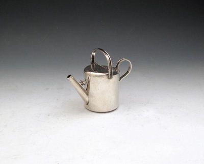 Appraisal: An Edwardian novelty silver watering can table cigar lighter by