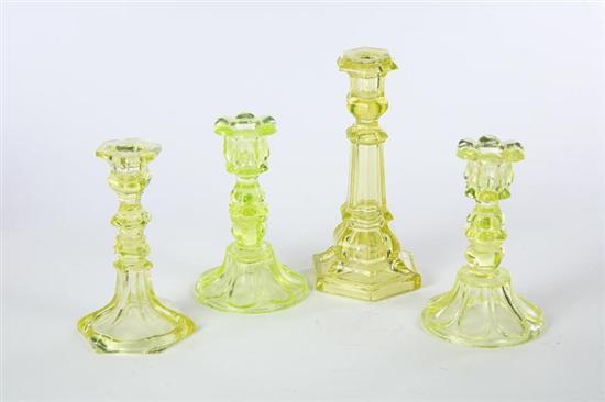 Appraisal: FOUR CANDLESTICKS American mid th century pressed glass Two have