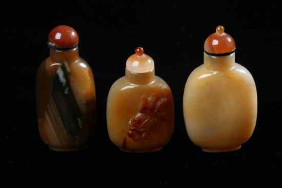 Appraisal: THREE CHINESE AGATE SNUFF BOTTLE th century Flattened ovoid-form one