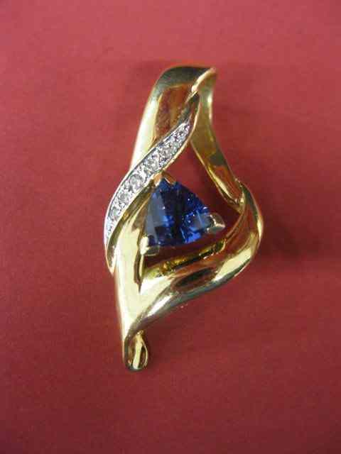 Appraisal: Tanzanite Diamond Pendant triangular gem weighing carats with diamonds totaling