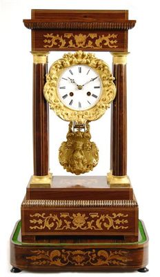 Appraisal: A rosewood and marquetry portico clock with an day movement