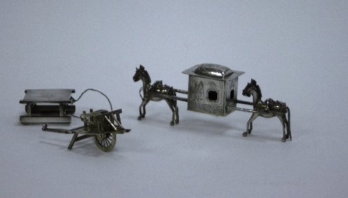 Appraisal: A Chinese silver wheelbarrow a sledge and a palanquin with