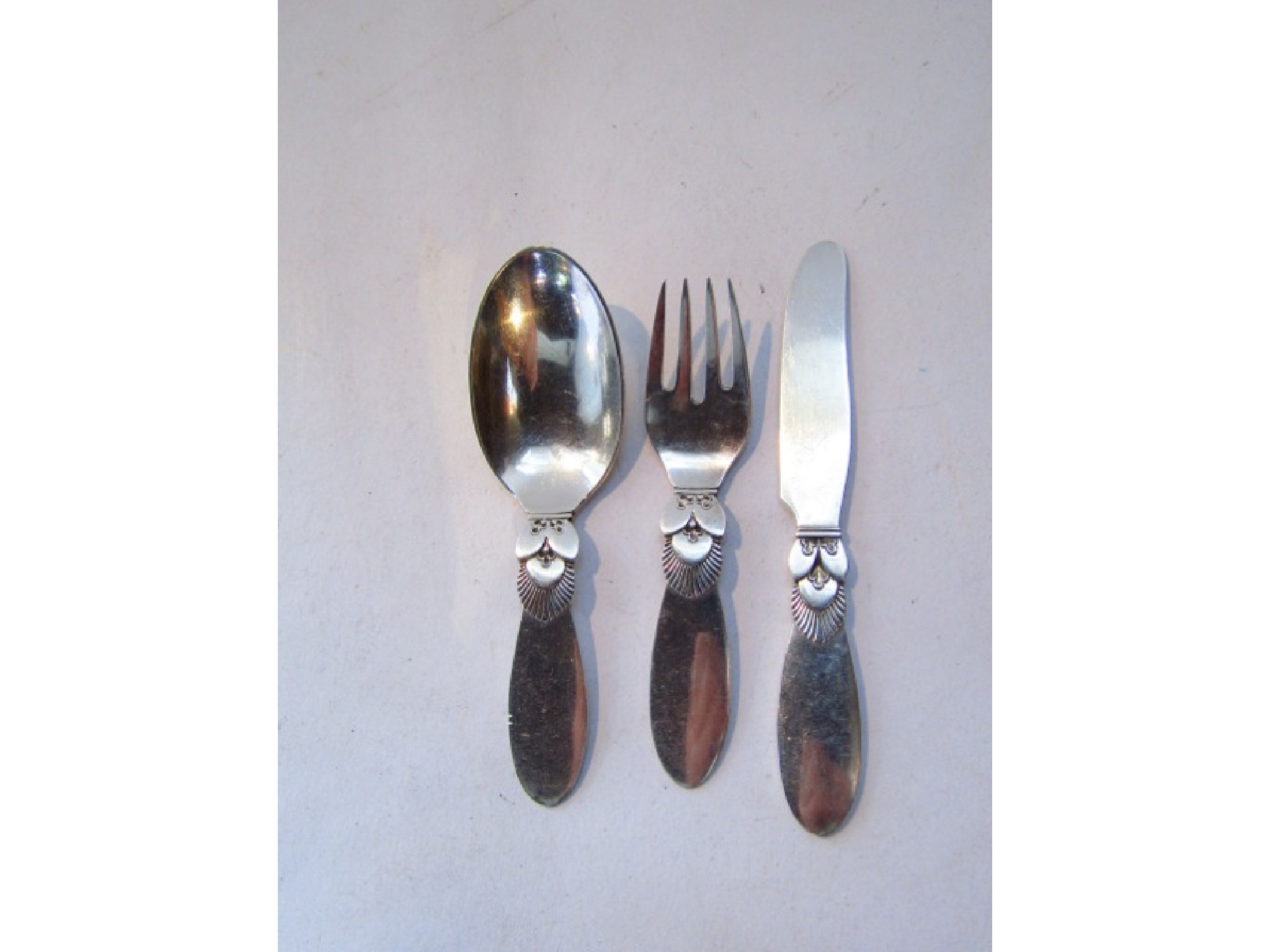 Appraisal: A Danish silver baby cutlery set Georg Jensen Silversmiths Ltd