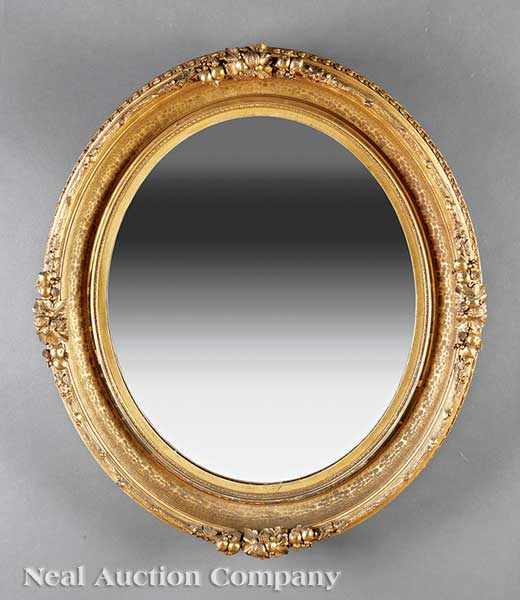 Appraisal: An Antique American Giltwood Mirror th c oval ogee-molded frame