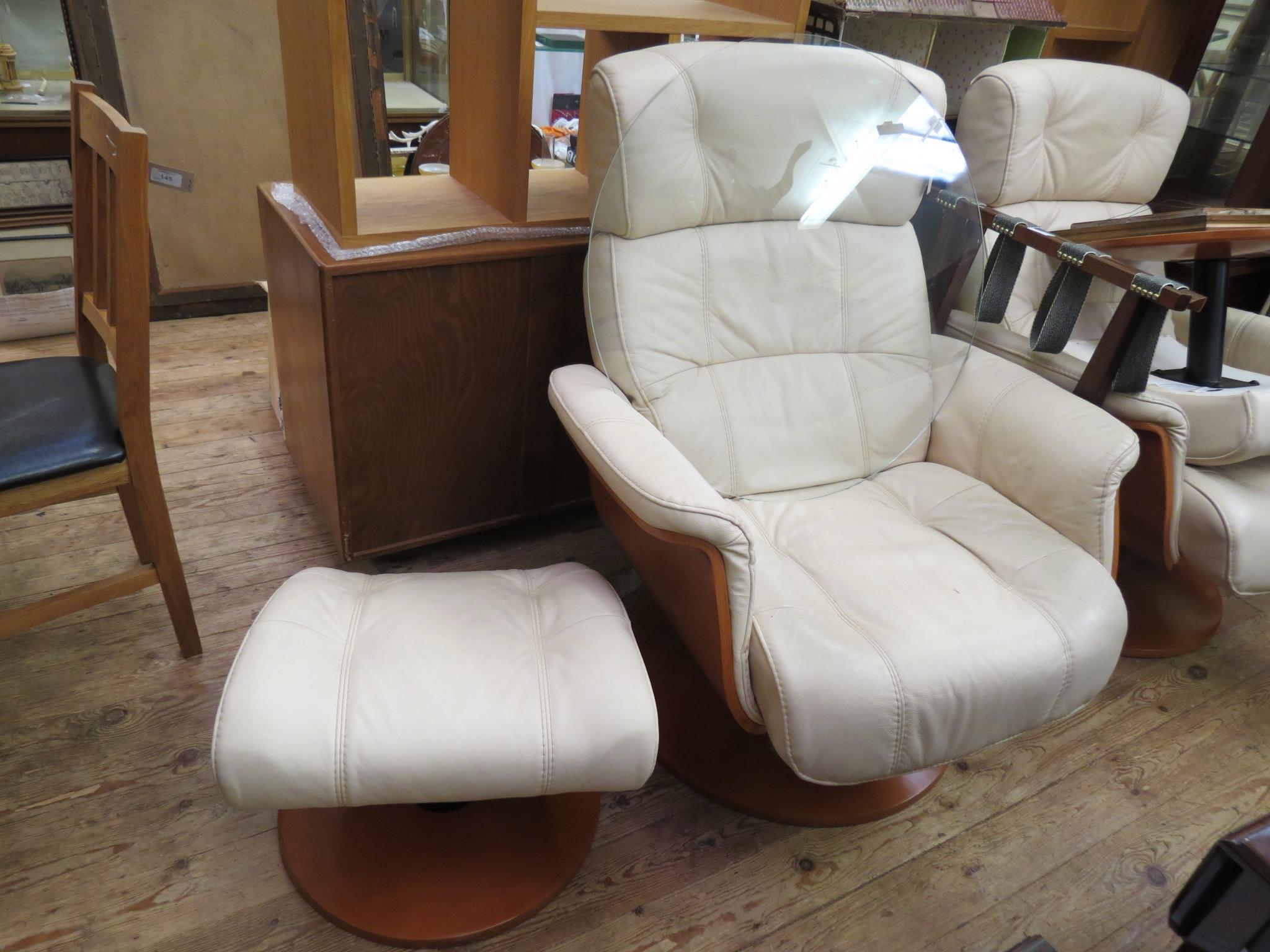 Appraisal: A pair of modern cream leather recliner armchairs revolving-action each