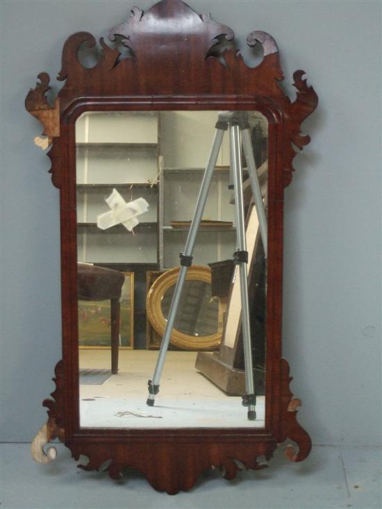 Appraisal: George III mahogany fret framed mirror with typical scroll and