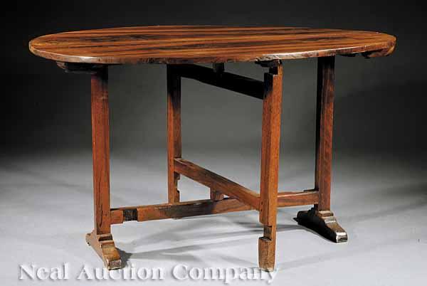 Appraisal: An Antique French Walnut Wine Table th c oval top