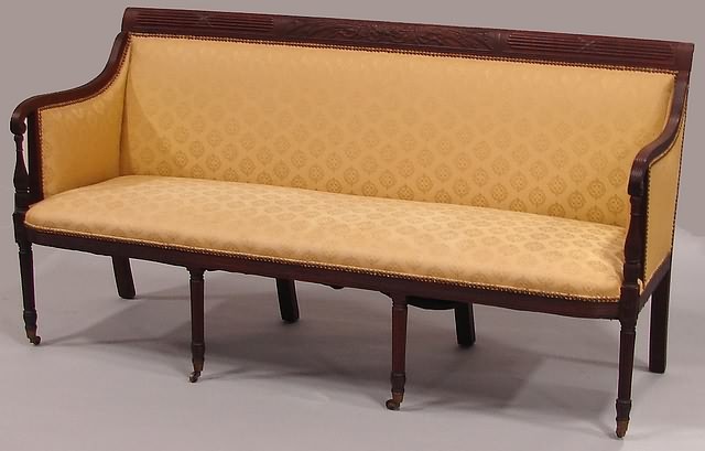 Appraisal: Mahogany wheat sheaf and ribbon carved crest scrolled reeded arms