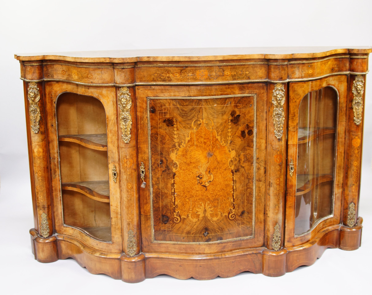 Appraisal: A Victorian walnut and inlaid credenza of serpentine form with