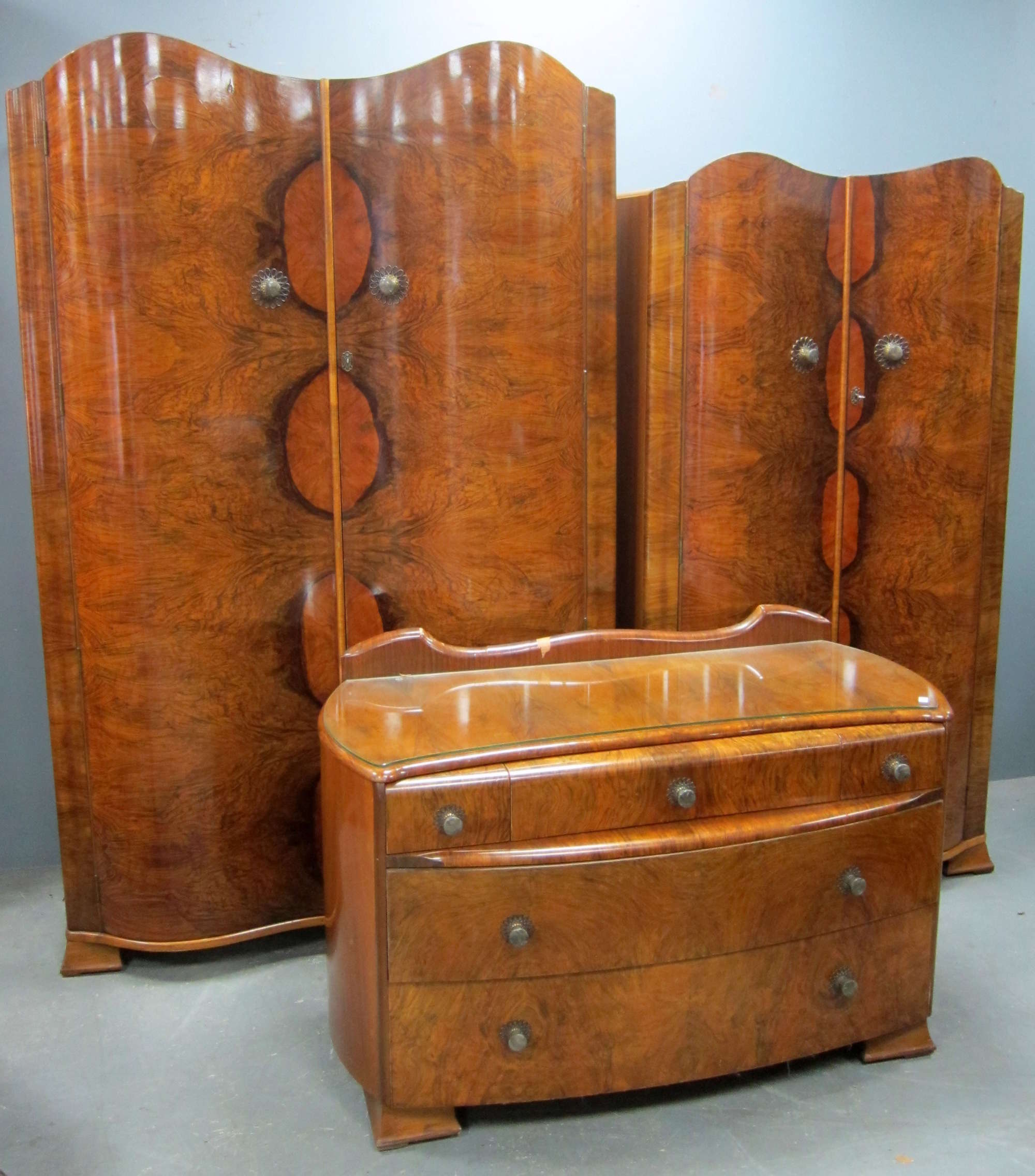 Appraisal: Walnut three piece serpentine fronted bedroom suite comprising wardrobe compactum