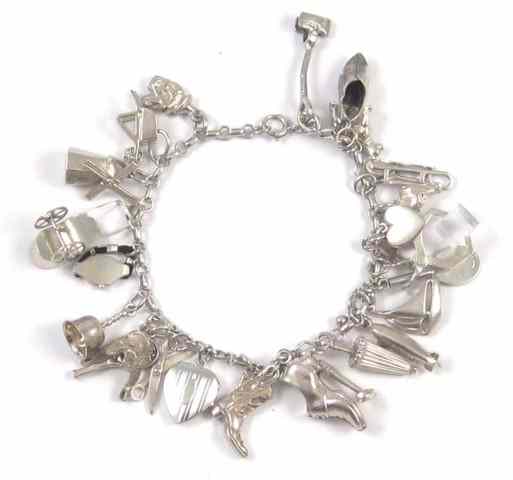 Appraisal: STERLING SILVER CHARM BRACELET with silver charms including shoes hearts