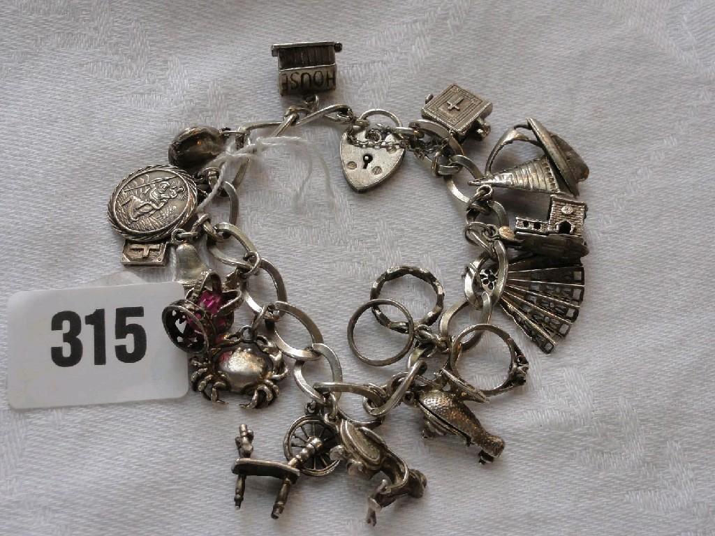 Appraisal: A charm bracelet with a number of silver and white