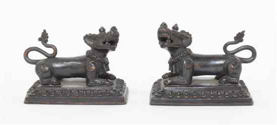 Appraisal: A Pair of Southeast Asian Bronze Lions depicted in opposing