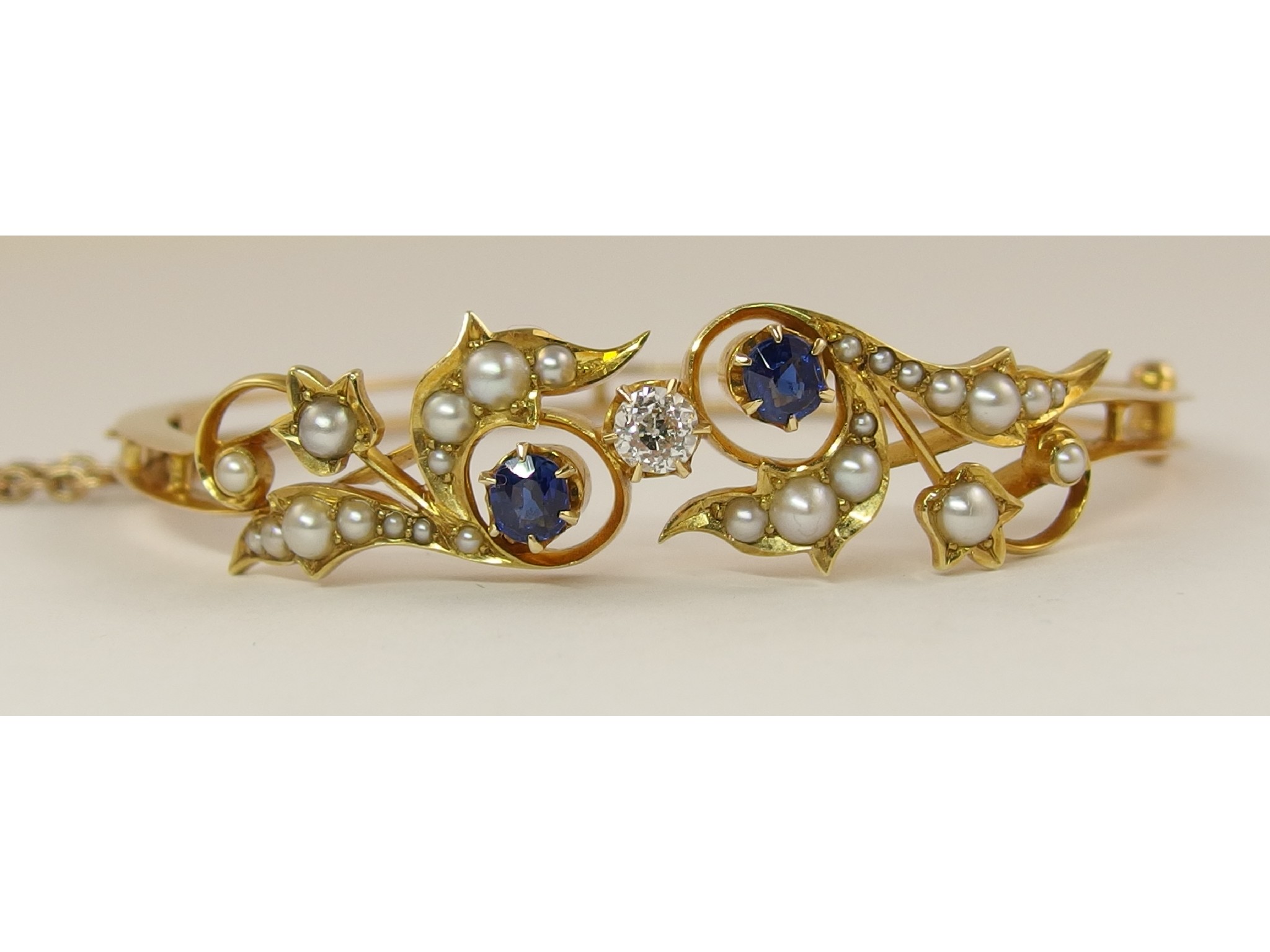 Appraisal: A Victorian diamond sapphire and pearl banglewith floral motif set