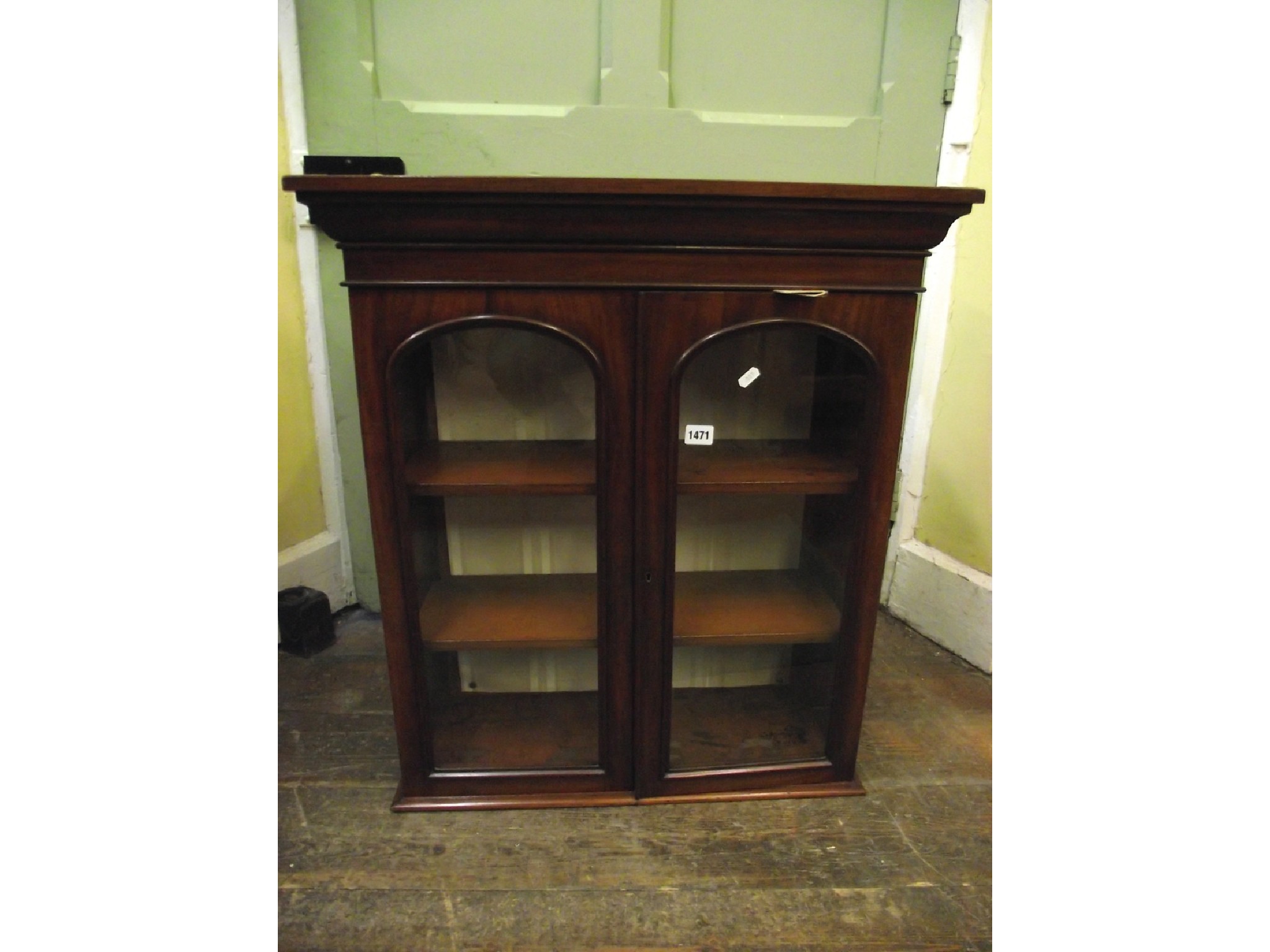 Appraisal: A neat Victorian mahogany wall hanging cupboard enclosed by two