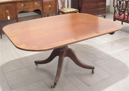 Appraisal: Georgian mahogany crossbanded breakfast table early th century The rounded