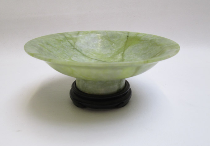 Appraisal: GREEN HARDSTONE FOOTED BOWL raised on wood plinth Diameter inches