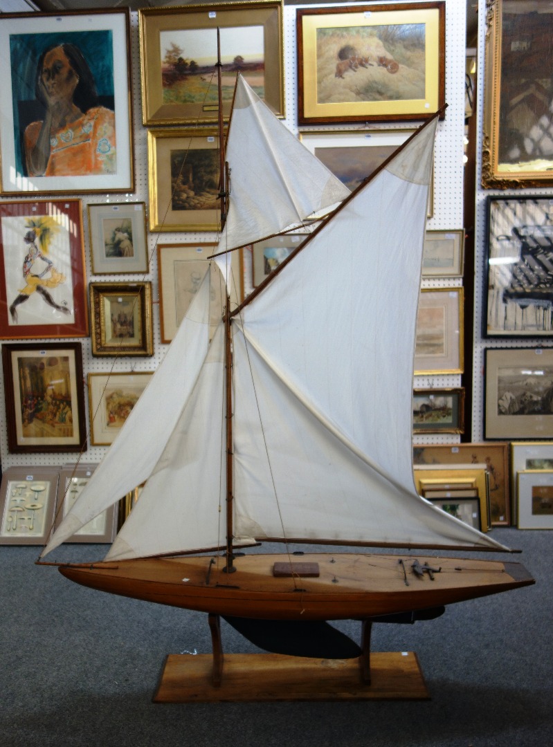 Appraisal: A wooden model sailing boat with lead lined keel and