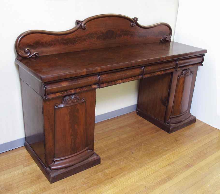 Appraisal: TH C MAHOGANY DOUBLE PEDESTAL SIDEBOARD Carved and shaped backsplash