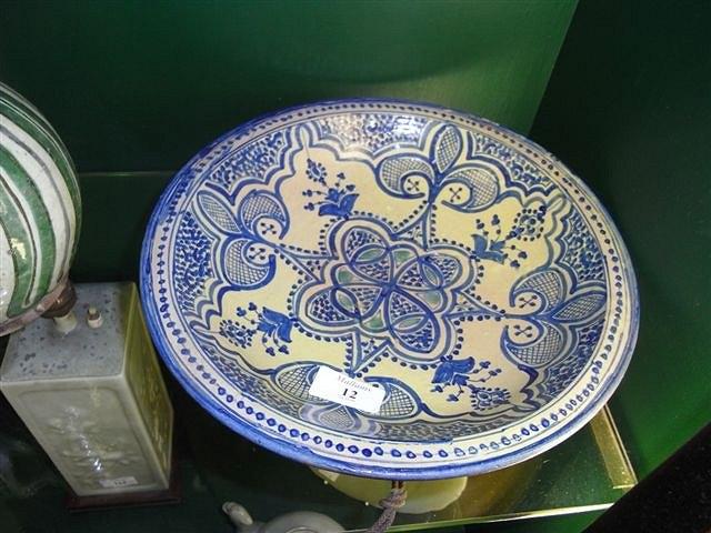 Appraisal: AN IZNIK DISH with blue and green flower and scrolling