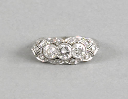 Appraisal: Platinum and diamond band with three full cut diamonds and