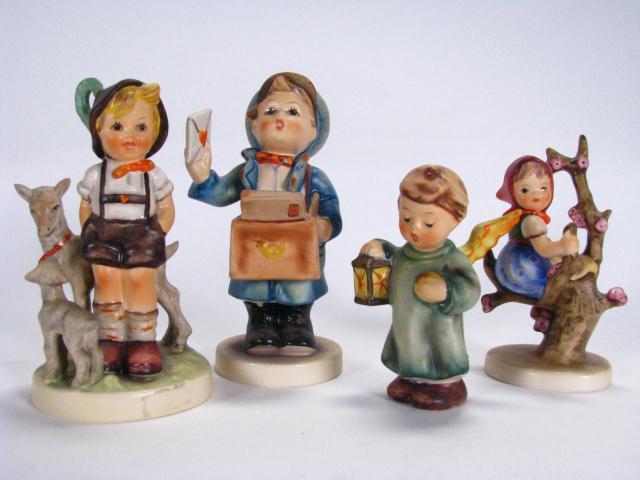 Appraisal: Four Goebel Hummel figurines including ''Goodnight'' '' tall ''Apple Tree