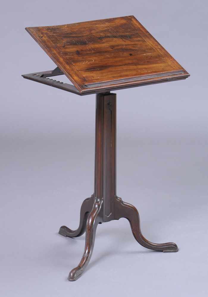 Appraisal: GEORGE III CARVED MAHOGANY TRIPOD READING STAND The hinged adjustable