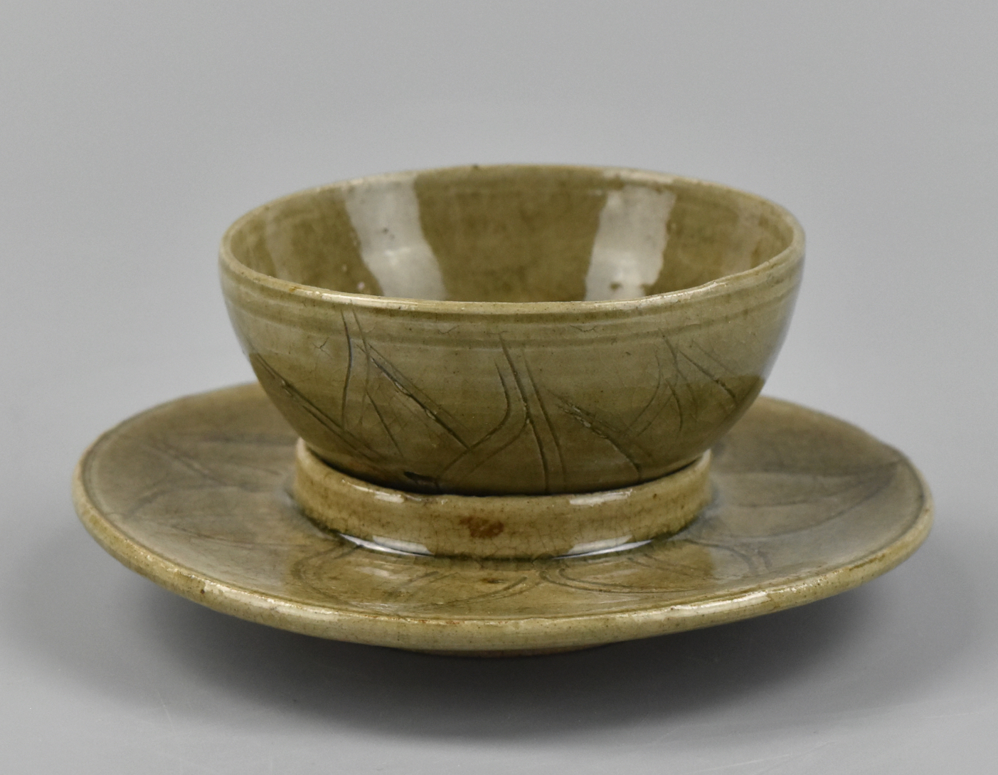 Appraisal: A Chinese yun ware celadon cup with holder saucer Tang