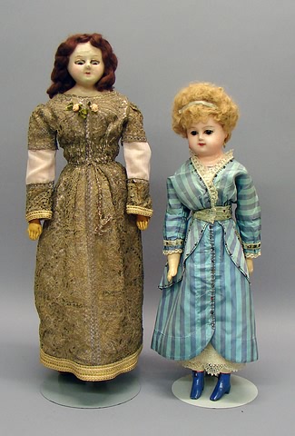 Appraisal: Pair of wax over papier mache dolls with black pupiless