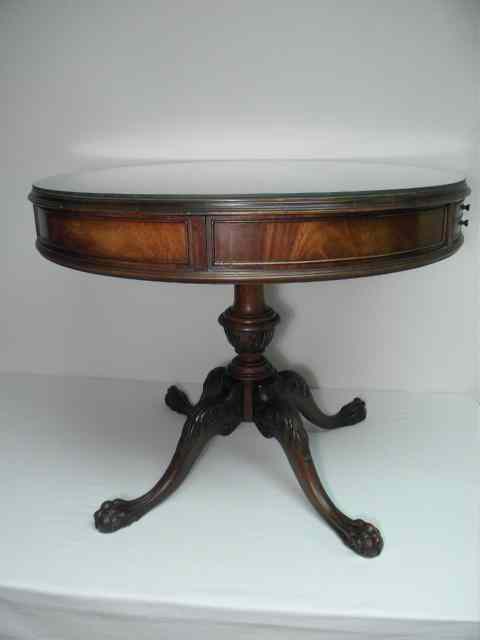 Appraisal: A leather top drub table on four ball and claw