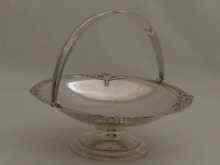 Appraisal: A swing handled cake stand with applied cast rim by