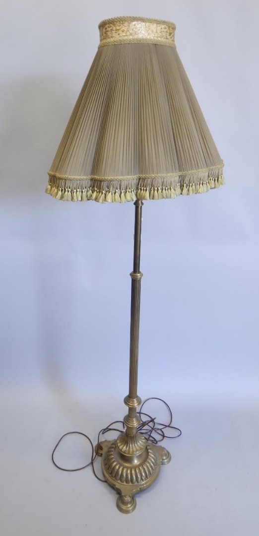 Appraisal: An early thC brass standard lamp with reeded column lobed