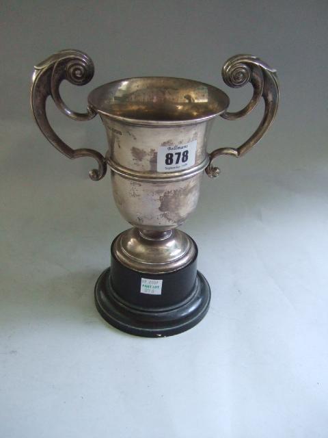 Appraisal: A silver twin handled trophy cup Sheffield with a black