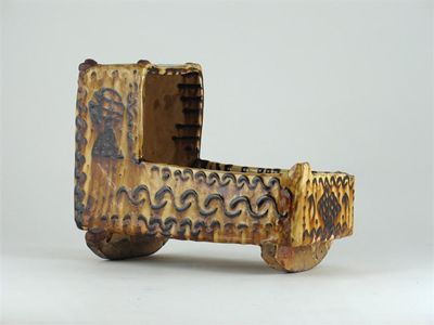 Appraisal: A slipware model of a cradle decorated in a buff