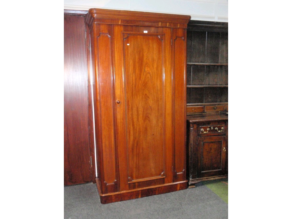 Appraisal: A Victorian mahogany single wardrobe with moulded cornice and raised