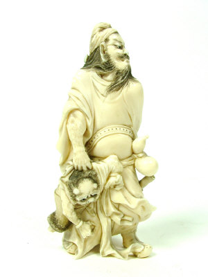 Appraisal: A Japanese ivory okimono carved as a bearded figure holding