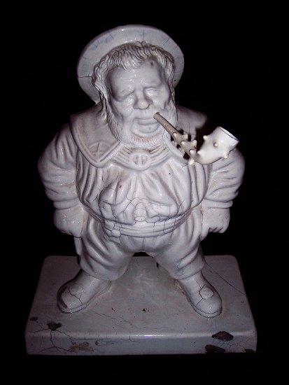 Appraisal: A white glazed figure of a portly gentleman dressed in