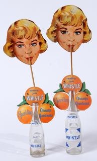 Appraisal: A pair of cardboard and wood Whistle advertising bottle toppers