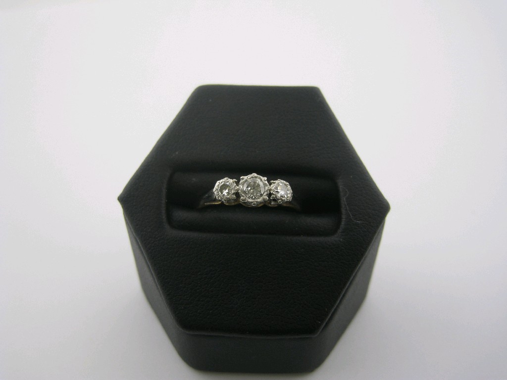 Appraisal: A Diamond three stone Ring the graduated brilliant-cut stones illusion-set