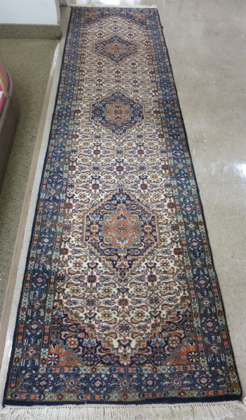 Appraisal: HAND KNOTTED ORIENTAL RUNNER Persian Bidjar design featuring three geometric