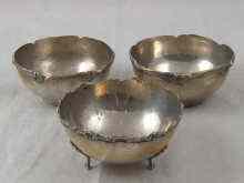 Appraisal: Three white metal tests silver bowls one with cast feet