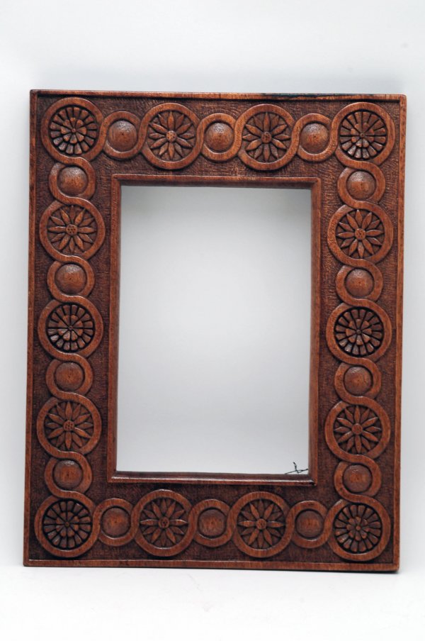 Appraisal: Wood frame carved with circular chain-type motif with alternating links