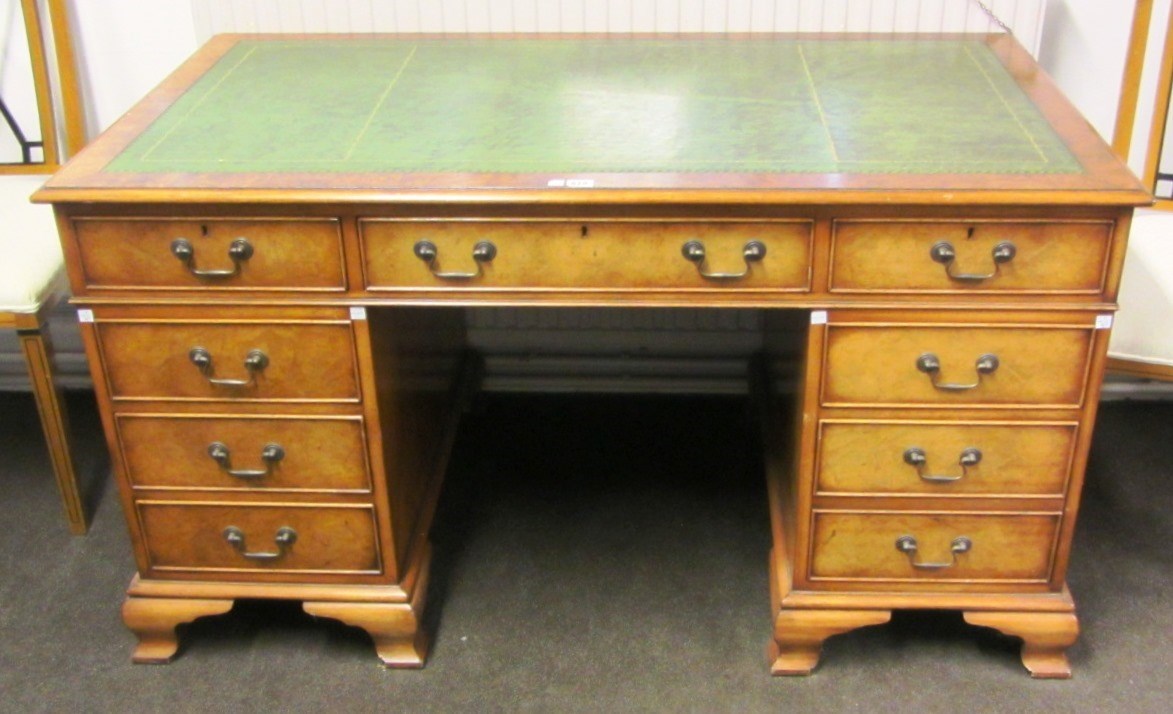 Appraisal: An th century style walnut pedestal desk with nine drawers