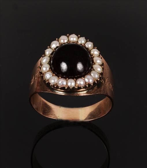 Appraisal: A garnet and half pearl ring s centring on a