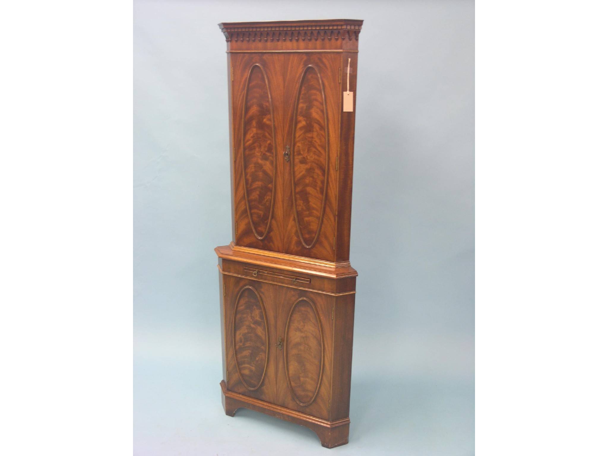 Appraisal: A Georgian-style flame-veneered mahogany corner cupboard floor-standing enclosed by two