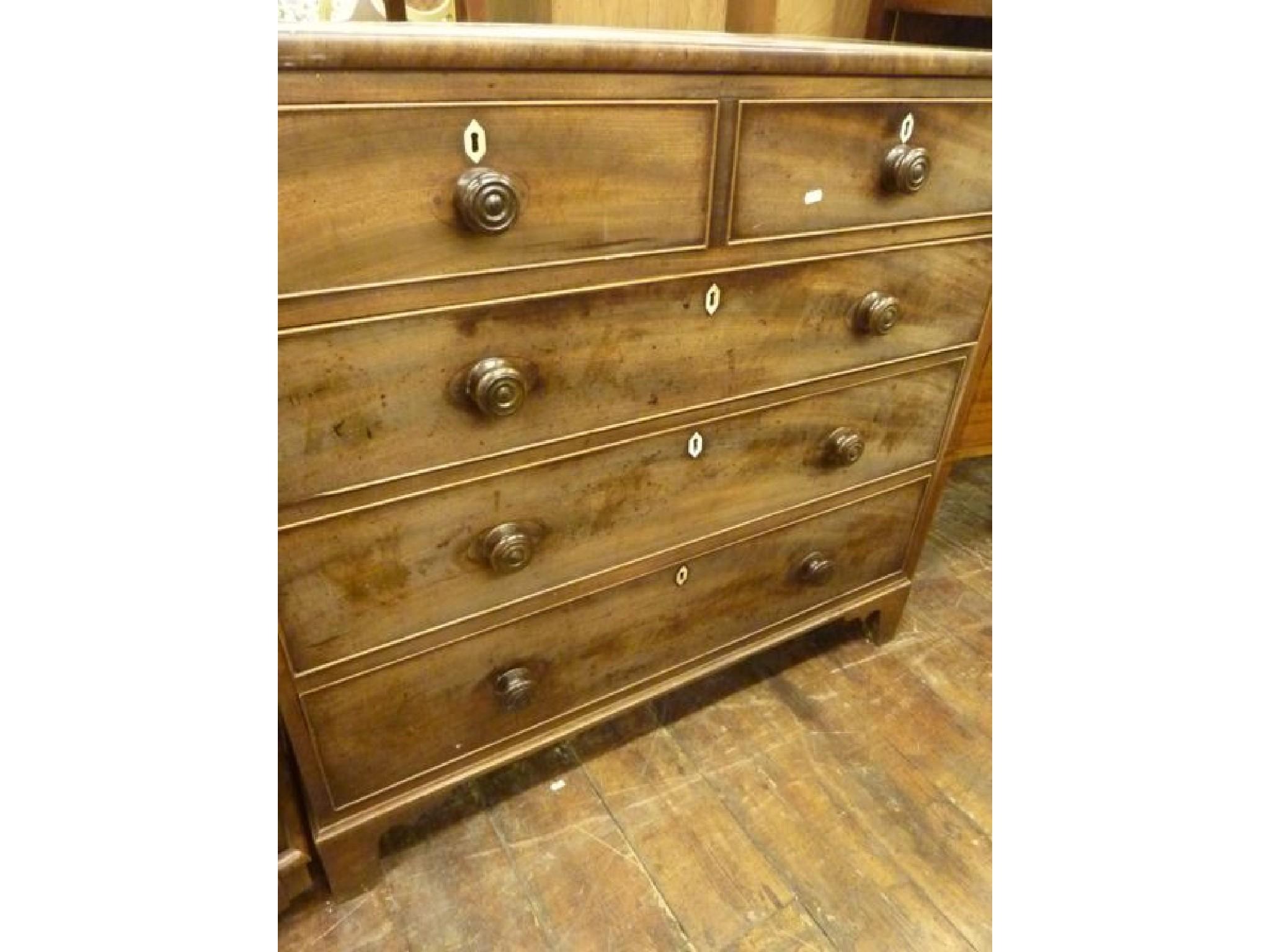 Appraisal: A Georgian mahogany chest fitted with three long and two