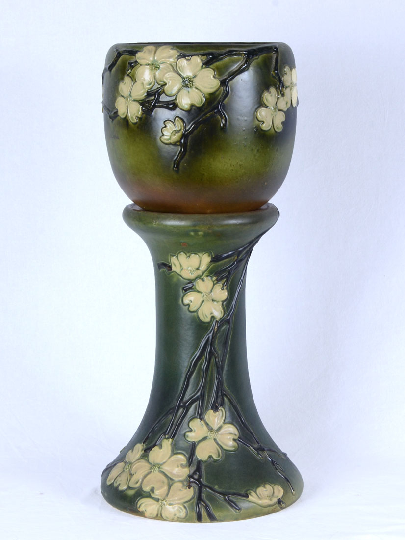 Appraisal: ROSEVILLE POTTERY DOGWOOD JARDINIERE AND PEDESTAL Green Dogwood pattern jardiniere