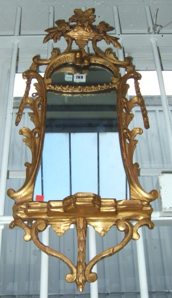 Appraisal: An th century gilt framed wall mirror with floral carved